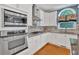 Modern kitchen with stainless steel appliances, granite countertops, backsplash, and ample storage space at 212 Thorncliff Way Way, Acworth, GA 30101
