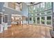 Open-concept living room with hardwood floors, a fireplace, large windows, and a view of the kitchen at 212 Thorncliff Way Way, Acworth, GA 30101