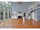 Spacious living room featuring hardwood floors, a fireplace, built-in shelves, and large windows at 212 Thorncliff Way Way, Acworth, GA 30101