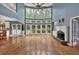 Bright and airy living room with a fireplace, hardwood flooring, and a wall of windows offering natural light at 212 Thorncliff Way Way, Acworth, GA 30101