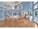 Open-concept living room with soaring ceilings, hardwood floors, a fireplace, and seamless flow to the kitchen area at 212 Thorncliff Way Way, Acworth, GA 30101