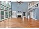 Spacious living room featuring hardwood floors, a fireplace, built-in shelves, and large windows at 212 Thorncliff Way Way, Acworth, GA 30101