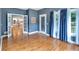 Open-concept room featuring hardwood floors, white trim, and natural light from multiple windows at 212 Thorncliff Way Way, Acworth, GA 30101