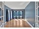 Sunlit living room featuring pristine hardwood floors and large windows adorned with elegant curtains at 212 Thorncliff Way Way, Acworth, GA 30101