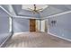 Spacious main bedroom with a ceiling fan, a barn door to the en-suite and neutral carpet at 212 Thorncliff Way Way, Acworth, GA 30101