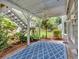 Spacious covered patio with stairs, a ceiling fan, and lush greenery, perfect for relaxing outdoors at 212 Thorncliff Way Way, Acworth, GA 30101