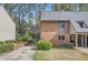 Brick exterior featuring an attached carport, manicured lawn, and verdant foliage at 2459 Cedar Canyon Se Ct, Marietta, GA 30067