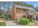 Charming brick exterior showcases a well-maintained lawn, carport, and lush landscaping at 2459 Cedar Canyon Se Ct, Marietta, GA 30067
