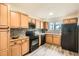 Updated kitchen featuring wood cabinets, black appliances, backsplash, countertops and gray wood flooring at 2459 Cedar Canyon Se Ct, Marietta, GA 30067