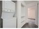 Convenient laundry area with stackable washer and dryer and open shelves for storage at 2459 Cedar Canyon Se Ct, Marietta, GA 30067