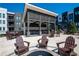 Picturesque community courtyard featuring a fire pit, covered area, and comfortable seating amidst modern architecture at 371 Grant Cir # 1812, Atlanta, GA 30315