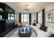 Well-lit living room featuring a sleek media center, wood floors, and contemporary decor at 371 Grant Cir # 1812, Atlanta, GA 30315