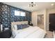 Inviting bedroom with a patterned accent wall, comfortable bed, and stylish bedside tables at 371 Grant Cir # 1812, Atlanta, GA 30315