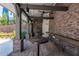 Outdoor kitchen with brick walls, exposed wooden beams, sink and countertops at 371 Grant Cir # 1812, Atlanta, GA 30315