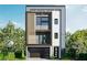Modern home featuring clean lines, vertical slat accents, balcony, and attached garage at 4931 Happy Hollow Rd, Atlanta, GA 30360