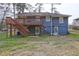 This charming home features a wooden deck and stairs leading to a spacious, grassy backyard perfect for outdoor entertaining at 32 Hillcrest Drive Southeast Se Dr, Austell, GA 30168