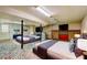 Bright basement featuring two beds, painted brick, colorful mosaic tile floor, and two TVs, perfect for recreation at 32 Hillcrest Drive Southeast Se Dr, Austell, GA 30168