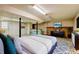 Finished basement with modern decor, featuring a bed, TV, and decorative tiling at 32 Hillcrest Drive Southeast Se Dr, Austell, GA 30168