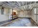 Unfinished basement with exposed ductwork, concrete floor, shelving unit, and painted brick, ready to be customized at 32 Hillcrest Drive Southeast Se Dr, Austell, GA 30168