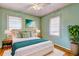 Well-decorated bedroom featuring a queen bed, green walls, hardwood floors, and bright natural light at 32 Hillcrest Drive Southeast Se Dr, Austell, GA 30168
