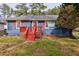 Charming blue single-story home featuring a red porch, red shutters, and a well-maintained front yard at 32 Hillcrest Drive Southeast Se Dr, Austell, GA 30168