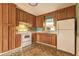 Charming kitchen features wood cabinets, white appliances, and a window above the sink for natural light at 32 Hillcrest Drive Southeast Se Dr, Austell, GA 30168