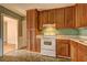 Traditional kitchen design featuring wood cabinets and white appliances, creating a cozy cooking space at 32 Hillcrest Drive Southeast Se Dr, Austell, GA 30168