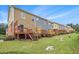 The townhome's backyards featuring wooden decks, staircases, and neatly manicured lawns at 801 Tulip Poplar Way # 2501, Lawrenceville, GA 30044