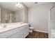 Bright bathroom with double sink vanity, dark wood floors, and glass-enclosed shower at 801 Tulip Poplar Way # 2501, Lawrenceville, GA 30044