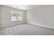 Bright bedroom featuring neutral walls, plush carpet, and a large window for natural light at 801 Tulip Poplar Way # 2501, Lawrenceville, GA 30044