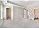 Large bedroom with neutral walls, plush carpeting, and multiple doorways at 801 Tulip Poplar Way # 2501, Lawrenceville, GA 30044