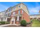View of the side of the townhome with brick and siding; also features a well-maintained lawn at 801 Tulip Poplar Way # 2501, Lawrenceville, GA 30044