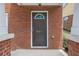 Close-up of front door with decorative glass and house number, surrounded by red brick at 801 Tulip Poplar Way # 2501, Lawrenceville, GA 30044