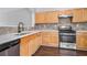 Kitchen with stainless steel appliances, light wood cabinets, white countertops, and dark wood-look floors at 801 Tulip Poplar Way # 2501, Lawrenceville, GA 30044