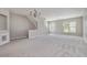 Neutral living room with a view to a staircase, large windows, and carpeted flooring at 801 Tulip Poplar Way # 2501, Lawrenceville, GA 30044
