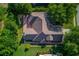 Aerial view of the home showing roof and brick patio nestled among mature trees at 805 River Valley Dr, Dacula, GA 30019