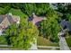 An aerial view of a home surrounded by mature trees in a neighborhood with a community pool at 805 River Valley Dr, Dacula, GA 30019