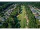 Overhead view of neighborhood golf course, surrounded by mature trees and houses at 805 River Valley Dr, Dacula, GA 30019