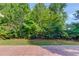 Enjoy a private backyard lined with mature trees off of the brick paver patio at 805 River Valley Dr, Dacula, GA 30019