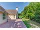 A lovely backyard with lush greenery and brick paver patio at 805 River Valley Dr, Dacula, GA 30019