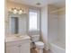 This bathroom features a vanity, window, and tiled shower-tub combination at 805 River Valley Dr, Dacula, GA 30019