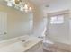 Bright bathroom with a large mirror, single sink vanity, and combined tub and shower at 805 River Valley Dr, Dacula, GA 30019