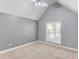 Empty bedroom featuring vaulted ceiling, neutral colors, and a window at 805 River Valley Dr, Dacula, GA 30019