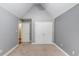 Bedroom features vaulted ceilings, neutral paint, and a double-door closet at 805 River Valley Dr, Dacula, GA 30019