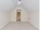 The bonus room with neutral carpet and paint boasts natural light and a ceiling fan at 805 River Valley Dr, Dacula, GA 30019