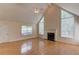 Bright living room with vaulted ceilings, a fireplace, and large windows for ample natural light at 805 River Valley Dr, Dacula, GA 30019