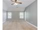 Spacious main bedroom with two large windows and a ceiling fan at 805 River Valley Dr, Dacula, GA 30019