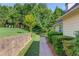 Well-maintained side yard with manicured hedges and a brick paver walkway at 805 River Valley Dr, Dacula, GA 30019