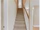 Carpeted stairway with white railing and wooden banister leading to the second floor at 805 River Valley Dr, Dacula, GA 30019