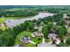 Aerial view of luxurious homes near a serene lake, surrounded by lush green trees at 106 April Walk, Mcdonough, GA 30253